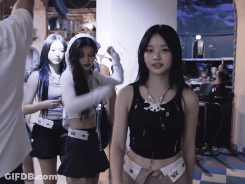 A Girl Wearing A Black Tank Top With A White Bunny On It GIF