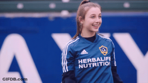 A Girl Wearing A Blue Adidas Herbalife Nutrition Shirt GIF