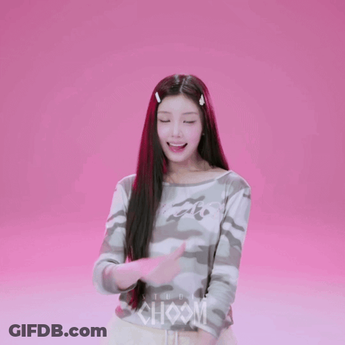 A Girl Wearing A Camouflage Shirt With The Word Studio On The Front GIF