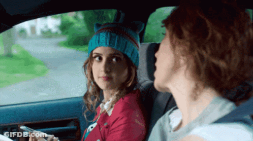 A Girl Wearing A Cat Hat Is Sitting In The Back Seat Of A Car With Another Girl GIF