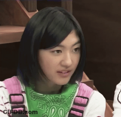 A Girl Wearing A Green Bandana And A Pink Shirt With The Letter D On It GIF