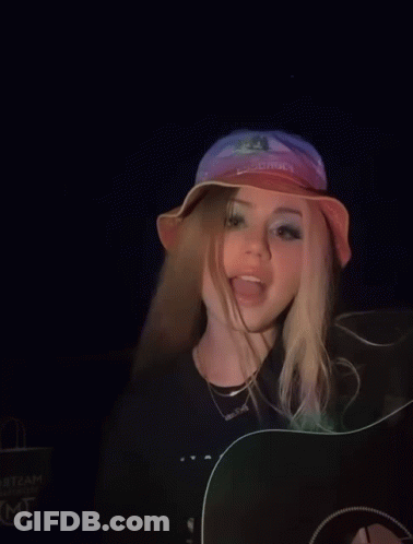 A Girl Wearing A Hat That Says Cowboys On It GIF