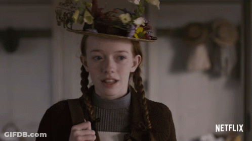 A Girl Wearing A Hat With Flowers On It And The Word Netflix On The Bottom GIF