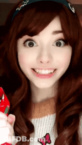 A Girl Wearing A Headband With A Skull On It Is Smiling GIF