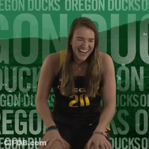 A Girl Wearing A Number 20 Jersey Is Laughing GIF