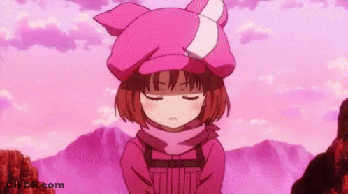 A Girl Wearing A Pink Hat And Scarf Is Standing In Front Of A Mountain With Her Eyes Closed . GIF
