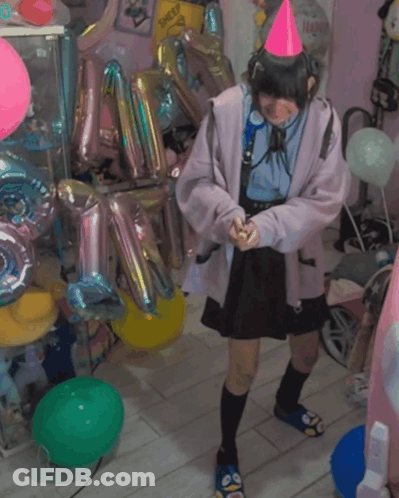 A Girl Wearing A Pink Party Hat Stands In A Room Filled With Balloons GIF