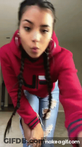 A Girl Wearing A Red Hoodie With The Letter J On The Front GIF