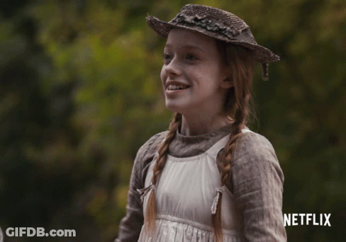 A Girl Wearing A Straw Hat And A White Dress With A Netflix Logo In The Corner GIF