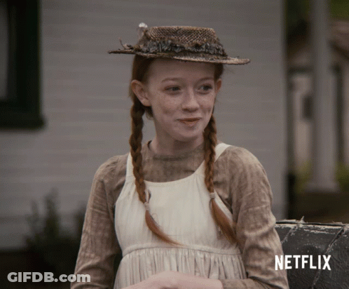 A Girl Wearing A Straw Hat And A White Dress With A Netflix Logo In The Corner GIF