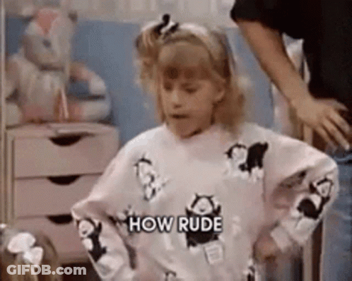 A Girl Wearing A Sweater That Says `` How Rude '' Is Standing Next To A Man . GIF