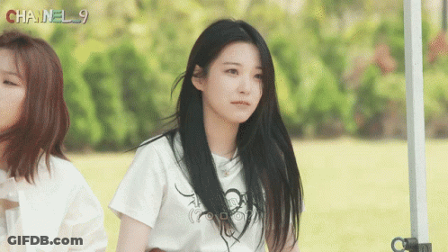 A Girl Wearing A White Shirt With Chanel 9 Written On It GIF