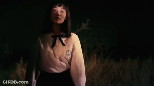 A Girl Wearing A White Shirt With The Letter G On The Front GIF