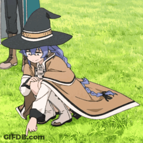 A Girl Wearing A Witch Hat Is Pointing At Something In The Grass GIF