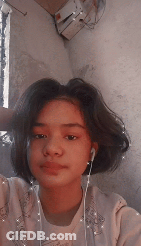 A Girl Wearing Ear Buds And A Shirt That Says ' I Love You ' On It GIF