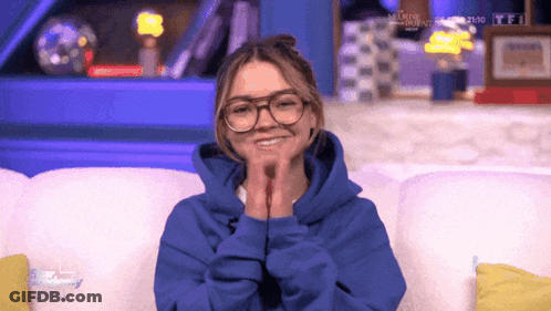 Girl With Glasses Smiling In Blue Hoodie GIF