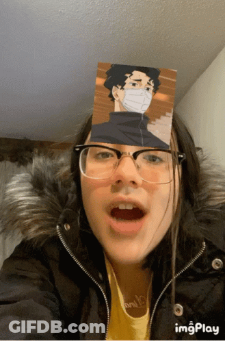 A Girl Wearing Glasses And A Fur Coat Has A Picture Of A Man On Her Face GIF