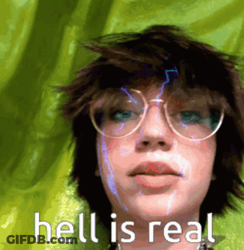 A Girl Wearing Glasses And A Green Shirt With The Words Hell Is Real On The Bottom GIF