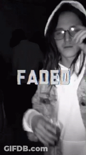 A Girl Wearing Glasses And A Hooded Jacket With Faded Written In White Letters GIF