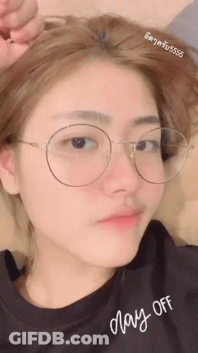 A Girl Wearing Glasses And A Shirt That Says May-Off GIF
