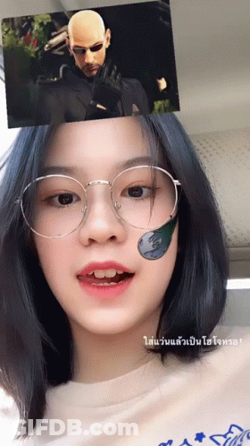 A Girl Wearing Glasses Has A Sticker On Her Face That Says ' Matrix ' GIF