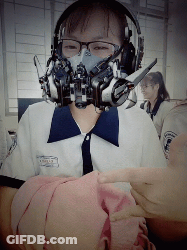 A Girl Wearing Headphones And A Gas Mask Has The Name Thanh Thao On Her Shirt GIF