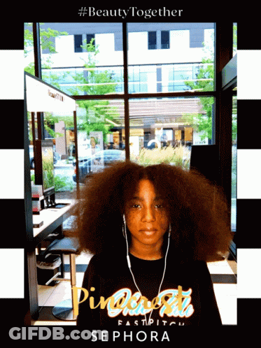 A Girl Wearing Headphones And A Shirt That Says Sephora On It GIF