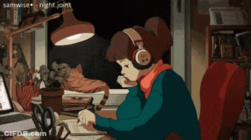 A Girl Wearing Headphones Is Sitting At A Desk With A Laptop GIF