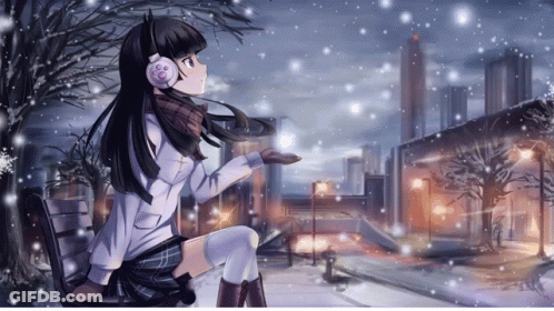 A Girl Wearing Headphones Sits In The Snow GIF