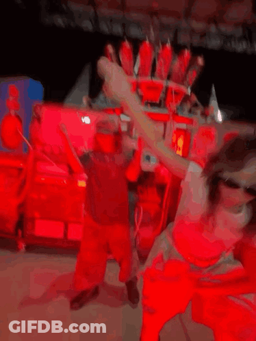 A Girl Wearing Sunglasses Is Dancing In Front Of A Machine That Says Coca Cola On It GIF