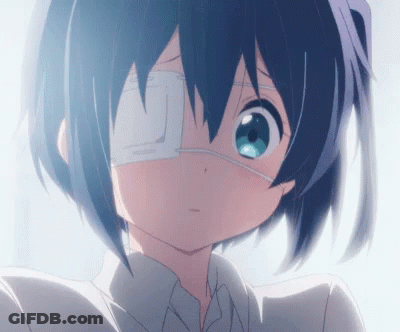 A Girl With A Bandage On Her Eye Looks At The Camera GIF
