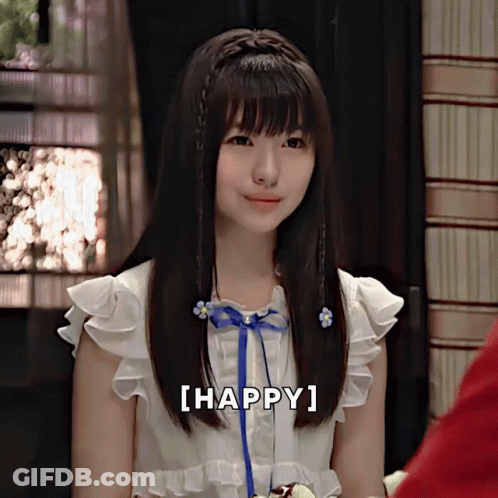 A Girl With A Blue Ribbon In Her Hair Is Smiling With The Words [ Happy ] Next To Her GIF