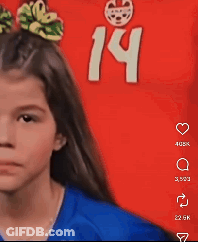 A Girl With A Bow In Her Hair Stands In Front Of A Red Background With The Number 14 GIF