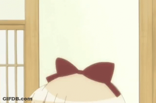A Girl With A Bow On Her Head Is Making A Funny Face GIF