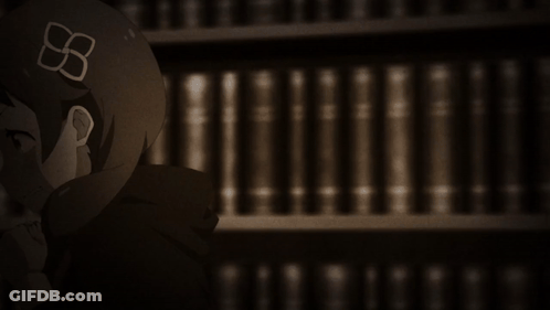 A Girl With A Bow On Her Head Is Reading A Book With Foreign Writing GIF