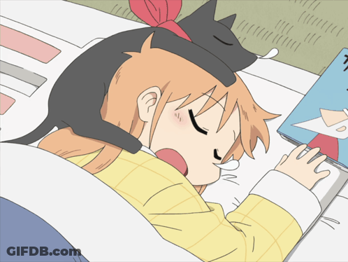 A Girl With A Cat On Her Head Sleeping Next To A Book GIF