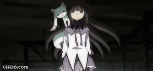 A Girl With A Cat On Her Shoulder Is Standing In The Dark GIF
