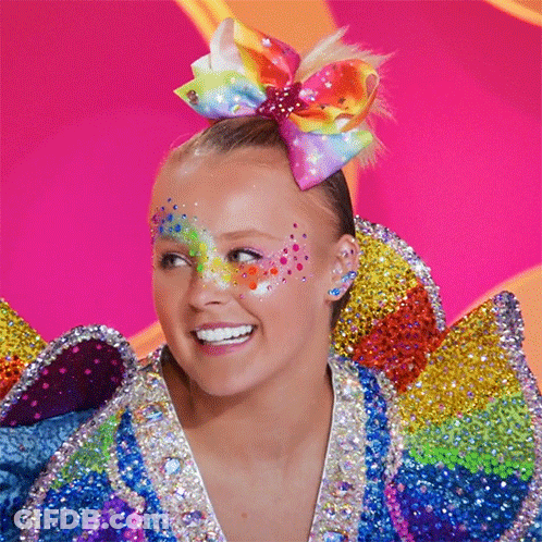 Girl With Colorful Bow Smiling GIF
