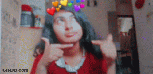 A Girl With A Crown Of Hearts On Her Head Is Making A Funny Face GIF