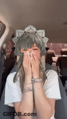 A Girl With A Crown On Her Head Is Covering Her Mouth With Her Hands GIF