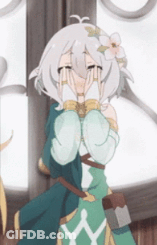 A Girl With A Flower In Her Hair Is Covering Her Face With Her Hands . GIF