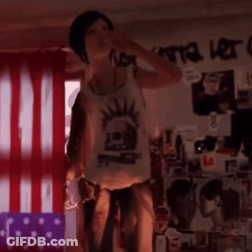 A Girl With A Mohawk On Her Back Is Being Lifted By A Man GIF