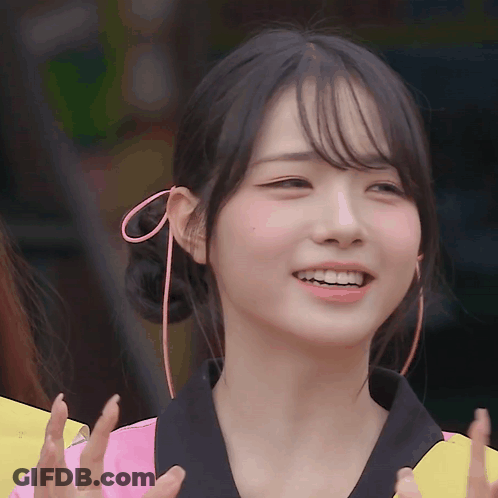 A Girl With A Pink Bow In Her Hair Smiles GIF
