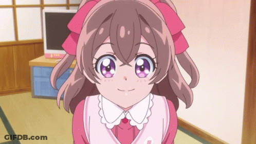 A Girl With A Pink Bow On Her Head Is Smiling GIF