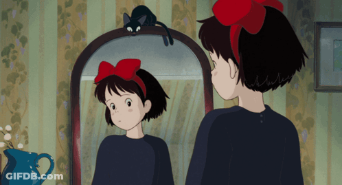 Girl With Red Bow Looking In Mirror GIF