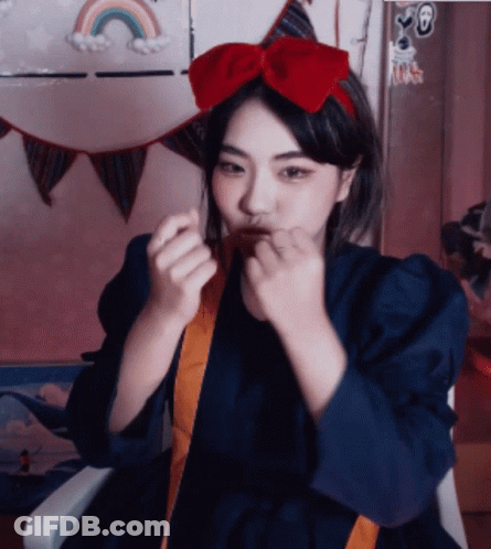 A Girl With A Red Bow On Her Head GIF