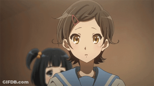 A Girl With A Red Ring In Her Hair Looks At The Camera GIF