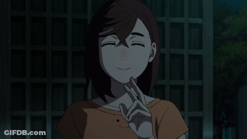 A Girl With A Smiley Face On Her Shirt Is Making A Peace Sign GIF