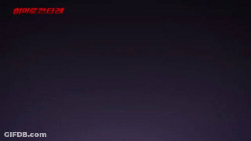 A Girl With A Star In Her Hand Stands In Front Of A Red Light GIF