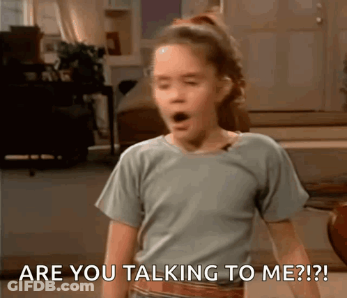 A Girl With A Surprised Look On Her Face Says Are You Talking To Me ? GIF